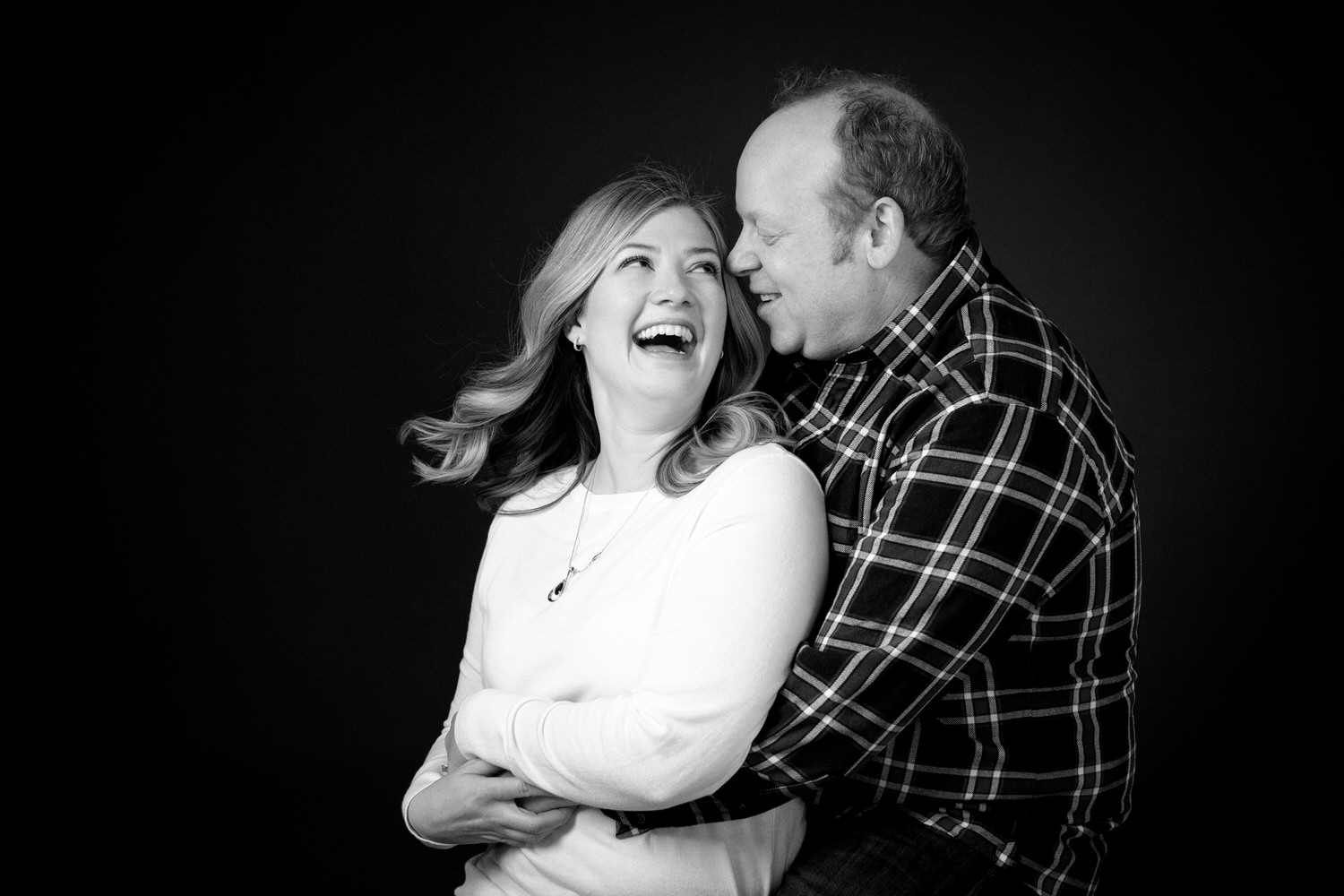a married couple photographed naturally during a relaxed professional studio shoot