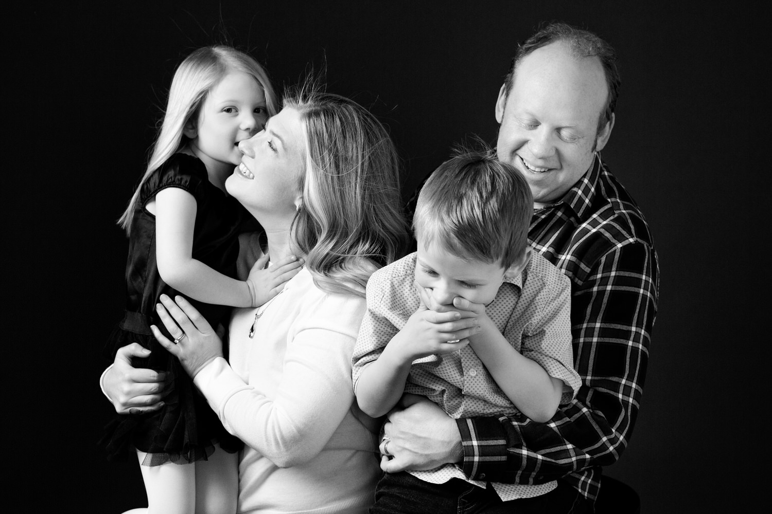 family of four having fun during a photography photo studio shoot in Calgary Alberta