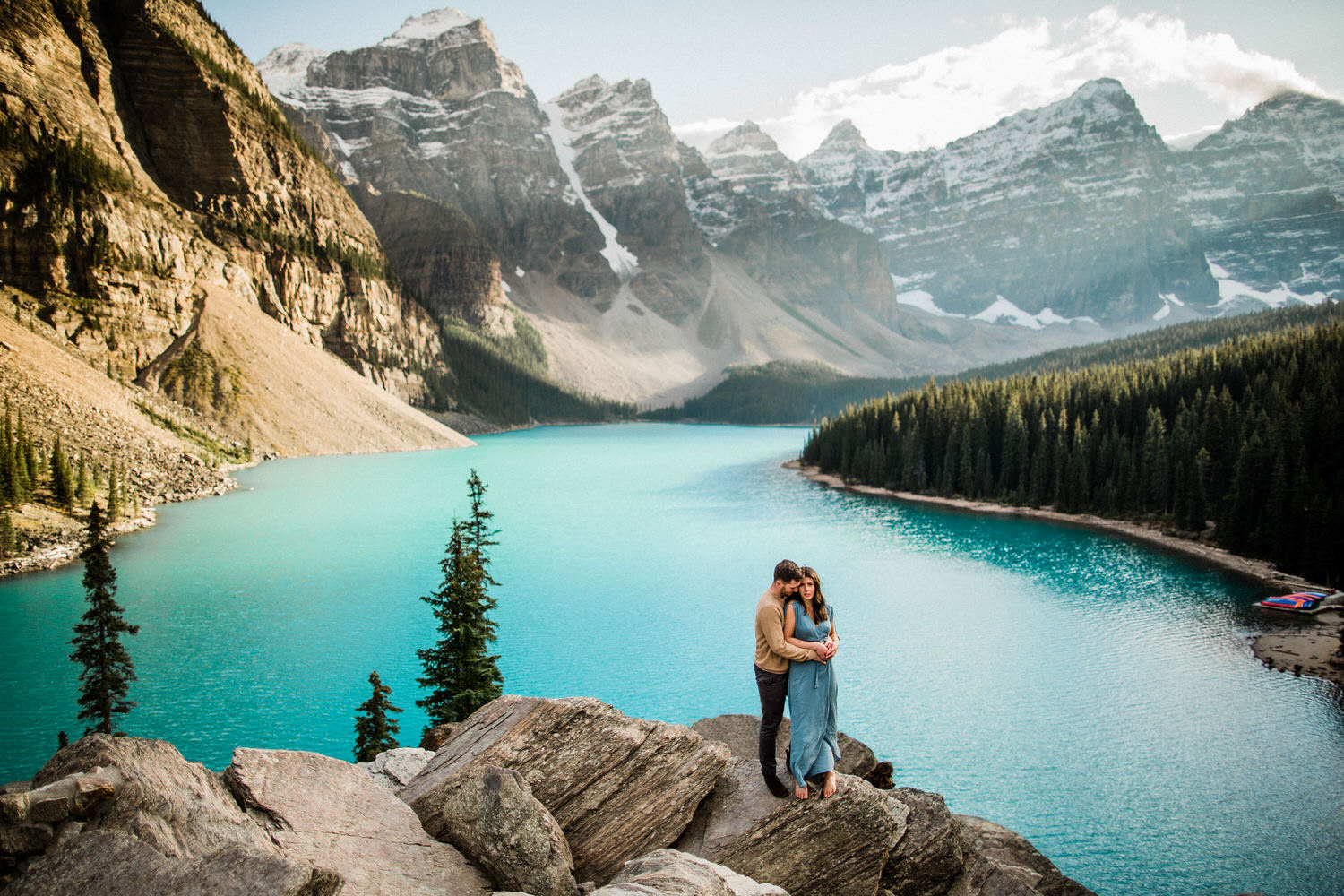 Turquoise water surrounding a newly engaged couple at Moraine Lake