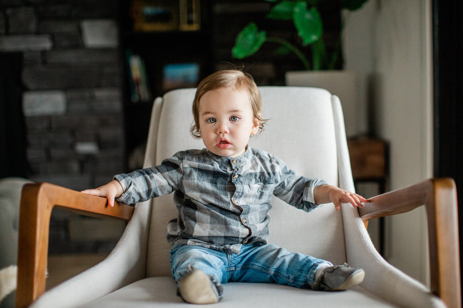 a toddler sitting on a chair during his photography session at his home in Calgary